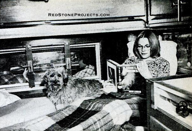 Front edge of the dinette table folds up for access to seats. Lower berth, occupied by author's daughter at right, consists of seat backs, folded down, with space between them bridged by the lowered dinette table.